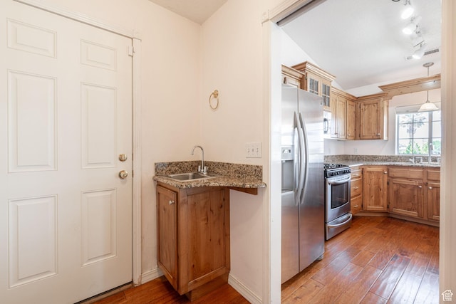 1055 E 900 S Unit 61, St George, UT 84790 - kitchen featuring stainless steel appliances, a sink, wood-type flooring, brown cabinets, and light stone counters