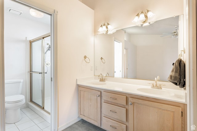 1055 E 900 S Unit 61, St George, UT 84790 - full bathroom featuring toilet, a stall shower, double vanity, tile patterned floors, and baseboards