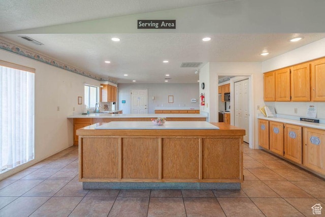 1055 E 900 S Unit 61, St George, UT 84790 - kitchen with light countertops, light tile patterned flooring, a center island, and recessed lighting
