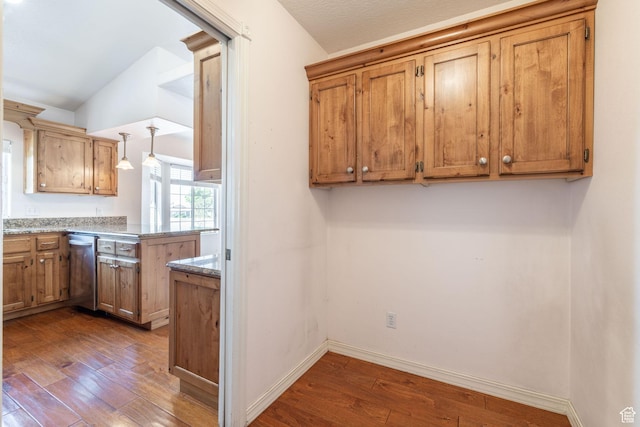 1055 E 900 S Unit 61, St George, UT 84790 - kitchen with stainless steel dishwasher, dark wood finished floors, lofted ceiling, a peninsula, and baseboards
