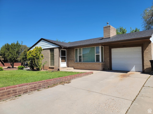 494 W 400 S, Cedar City, UT 84720 - ranch-style house with brick siding, an attached garage, a chimney, concrete driveway, and a front lawn
