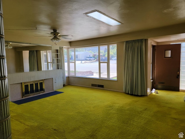 494 W 400 S, Cedar City, UT 84720 - unfurnished living room with a fireplace with flush hearth, ceiling fan, carpet flooring, and baseboards