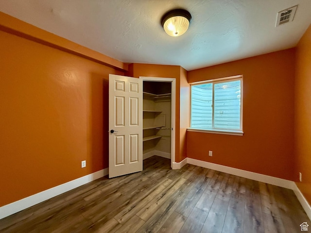 3870 S 2500 E, Vernal, UT 84078 - unfurnished bedroom featuring baseboards, wood finished floors, and a closet