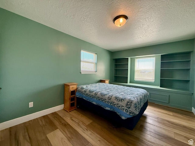 3870 S 2500 E, Vernal, UT 84078 - bedroom with a textured ceiling, multiple windows, wood finished floors, and baseboards