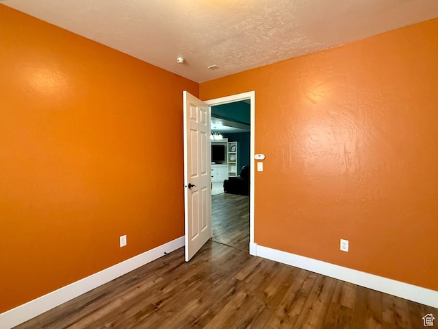 3870 S 2500 E, Vernal, UT 84078 - spare room featuring baseboards and dark wood finished floors