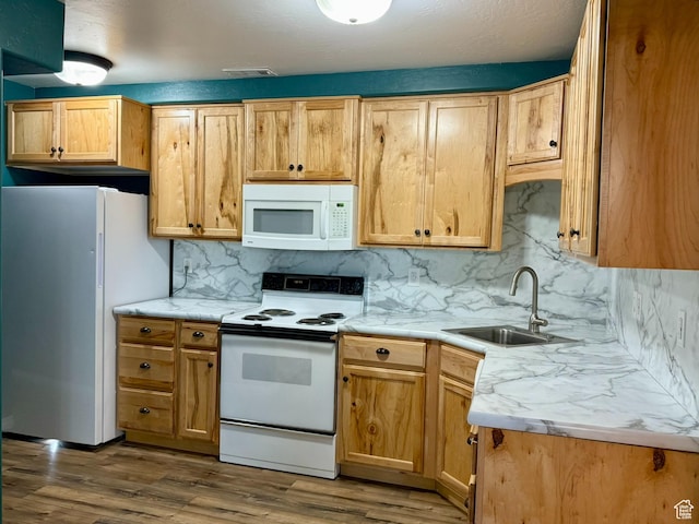 3870 S 2500 E, Vernal, UT 84078 - kitchen featuring white appliances, a sink, decorative backsplash, wood finished floors, and light countertops