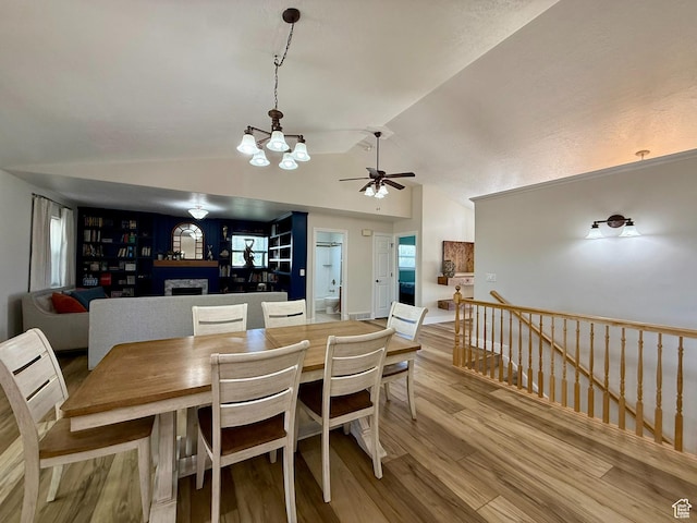 3870 S 2500 E, Vernal, UT 84078 - dining room with ceiling fan, lofted ceiling, wood finished floors, a chandelier, and a fireplace