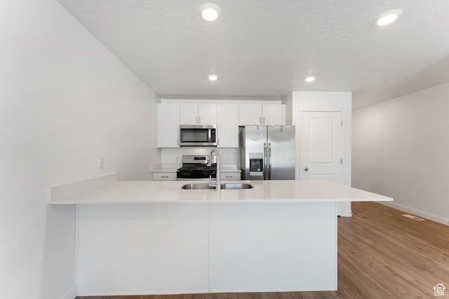 3457 E 1320 S, Spanish Fork, UT 84660 - kitchen with appliances with stainless steel finishes, a sink, baseboards, white cabinets, and a peninsula