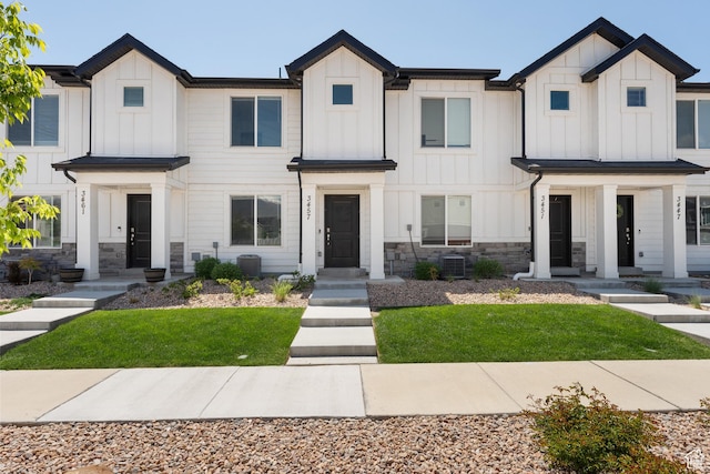 3457 E 1320 S, Spanish Fork, UT 84660 - modern farmhouse with board and batten siding, stone siding, cooling unit, and a front lawn