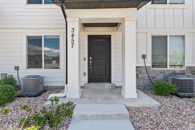 3457 E 1320 S, Spanish Fork, UT 84660 - doorway to property with central AC unit, board and batten siding, and stone siding