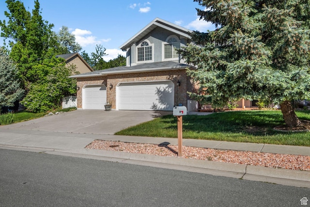 2239 E 3225 N, Layton, UT 84040 - view of front of property with driveway, a front yard, brick siding, and an attached garage