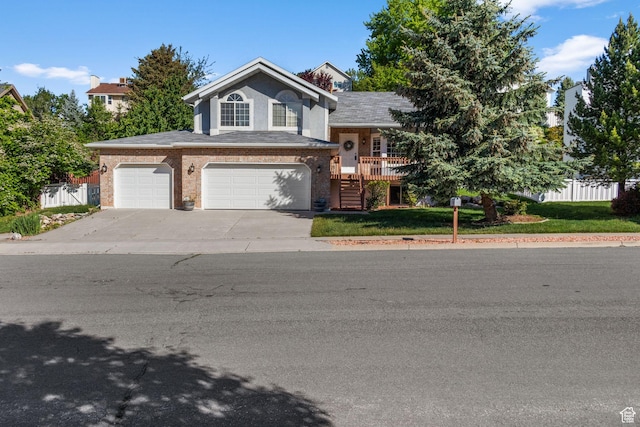 2239 E 3225 N, Layton, UT 84040 - tri-level home with driveway, an attached garage, brick siding, and stairs