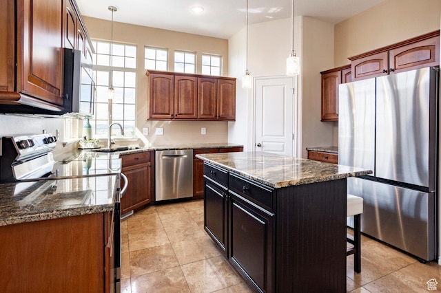 2271 W New Harvest Ln, Lehi, UT 84043 - kitchen with stainless steel appliances, dark stone counters, decorative light fixtures, a breakfast bar area, and a sink