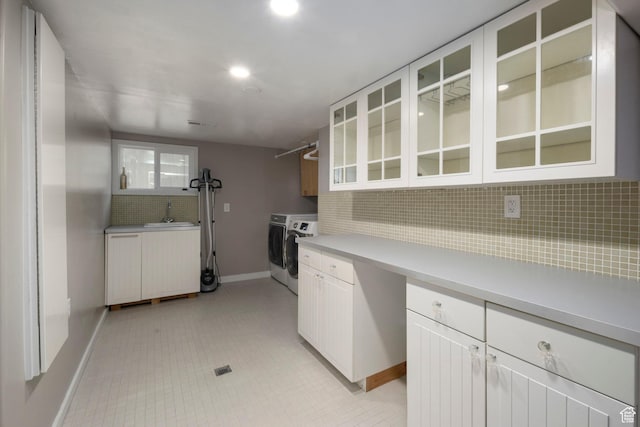 425 N 1300 W, Salt Lake City, UT 84116 - kitchen with washing machine and clothes dryer, tasteful backsplash, baseboards, light countertops, and glass insert cabinets