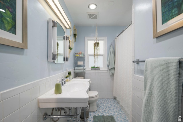 425 N 1300 W, Salt Lake City, UT 84116 - bathroom featuring tile walls, a sink, toilet, tile patterned flooring, and wainscoting