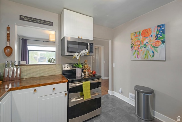 425 N 1300 W, Salt Lake City, UT 84116 - kitchen featuring stainless steel appliances, decorative backsplash, wood counters, and baseboards