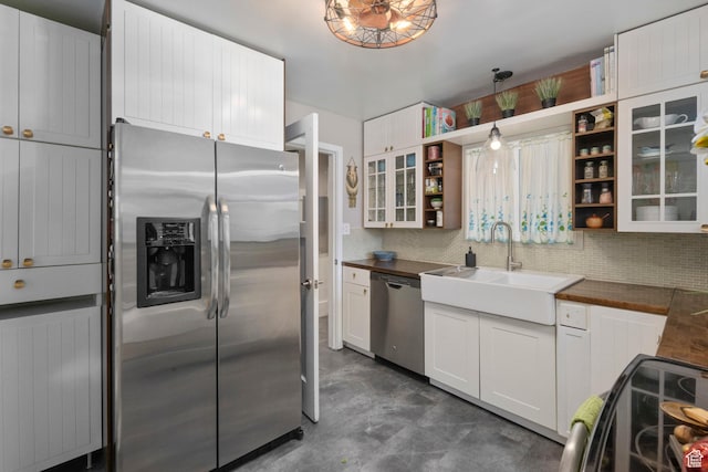 425 N 1300 W, Salt Lake City, UT 84116 - kitchen featuring stainless steel appliances, a sink, open shelves, backsplash, and white cabinets
