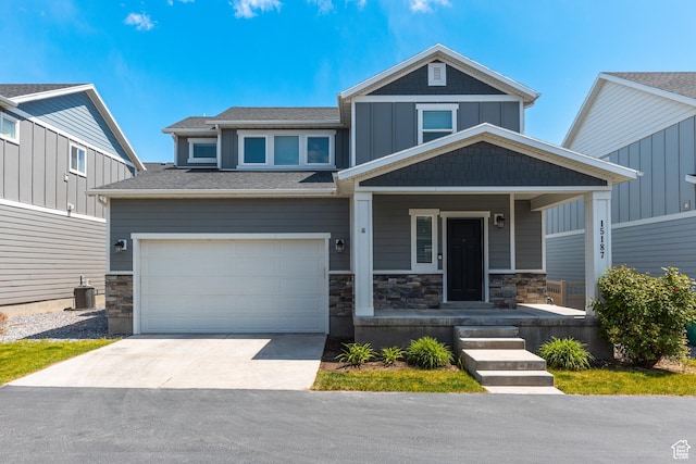 15187 S Sabre Pl, Bluffdale, UT 84065 - craftsman inspired home with driveway, an attached garage, stone siding, and covered porch