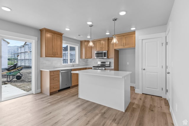 515 S 1580 W Unit 119, Logan, UT 84321 - kitchen with appliances with stainless steel finishes, light wood-style flooring, light countertops, tasteful backsplash, and recessed lighting