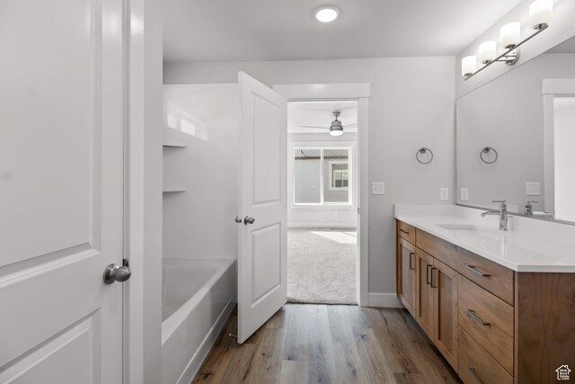 515 S 1580 W Unit 119, Logan, UT 84321 - bathroom featuring vanity, wood finished floors, a ceiling fan, a bathtub, and baseboards