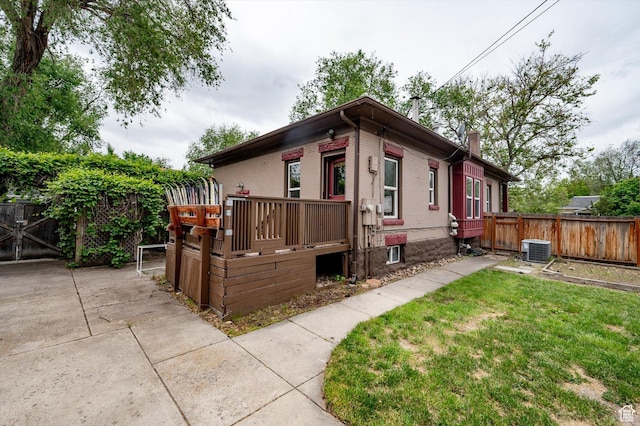 625 S 400 E, Salt Lake City, UT 84111 - view of front of house featuring central air condition unit, a chimney, a deck, and brick siding