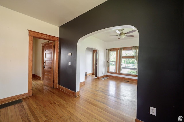 625 S 400 E, Salt Lake City, UT 84111 - unfurnished room with arched walkways, ceiling fan, light wood-type flooring, and baseboards