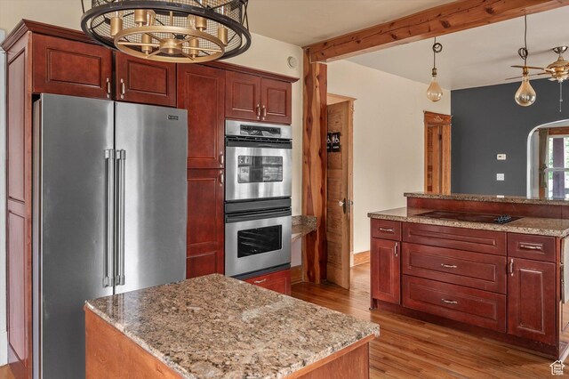 625 S 400 E, Salt Lake City, UT 84111 - kitchen featuring appliances with stainless steel finishes, light wood-style flooring, a kitchen island, pendant lighting, and light stone countertops