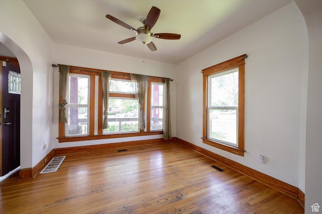 625 S 400 E, Salt Lake City, UT 84111 - unfurnished room with arched walkways, baseboards, wood finished floors, and a ceiling fan