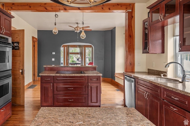 625 S 400 E, Salt Lake City, UT 84111 - kitchen with a sink, light wood-style flooring, stainless steel appliances, arched walkways, and baseboards