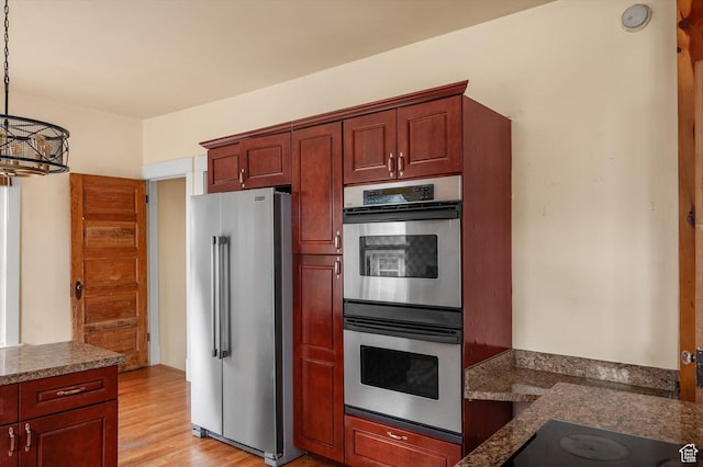 625 S 400 E, Salt Lake City, UT 84111 - kitchen with stainless steel appliances, light wood-type flooring, pendant lighting, and dark stone counters
