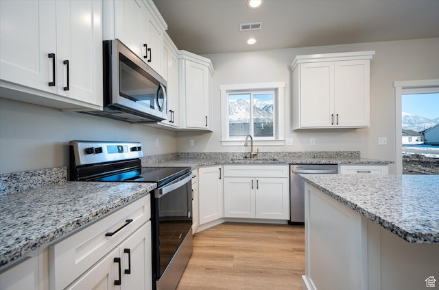 1244 N 350 W Unit 35, Brigham City, UT 84302 - kitchen featuring stainless steel appliances, light wood-style flooring, healthy amount of natural light, white cabinetry, and recessed lighting