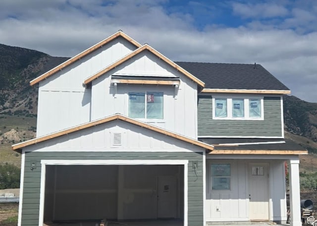 1244 N 350 W Unit 35, Brigham City, UT 84302 - view of front of home with a garage, a mountain view, board and batten siding, and roof with shingles