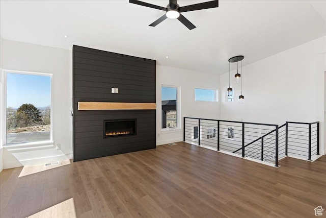 1568 Hudson St Unit 1, Ogden, UT 84404 - unfurnished living room with wood finished floors, a ceiling fan, and a fireplace