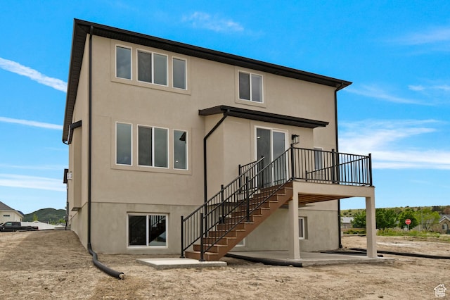 1323 E 370 S, Payson, UT 84651 - rear view of house featuring a patio, stucco siding, stairway, and a wooden deck