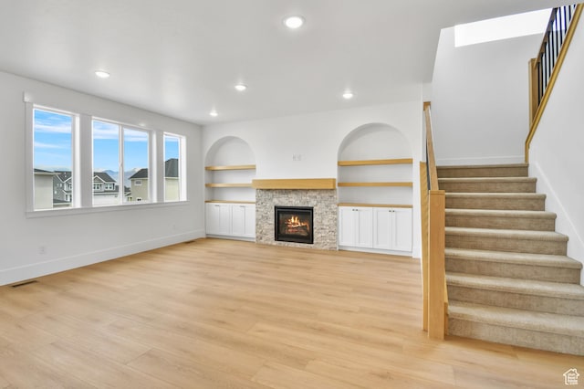 1323 E 370 S, Payson, UT 84651 - unfurnished living room featuring stairway, light wood finished floors, baseboards, a glass covered fireplace, and recessed lighting