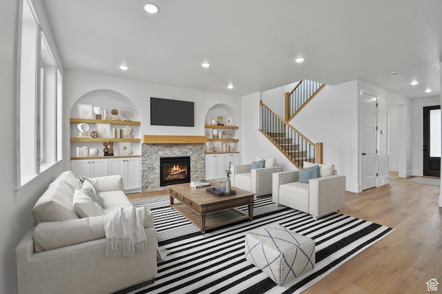 1323 E 370 S, Payson, UT 84651 - living area featuring light wood-type flooring, a stone fireplace, recessed lighting, baseboards, and stairs