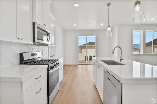 1323 E 370 S, Payson, UT 84651 - kitchen featuring stainless steel appliances, a sink, a kitchen island with sink, backsplash, and light countertops