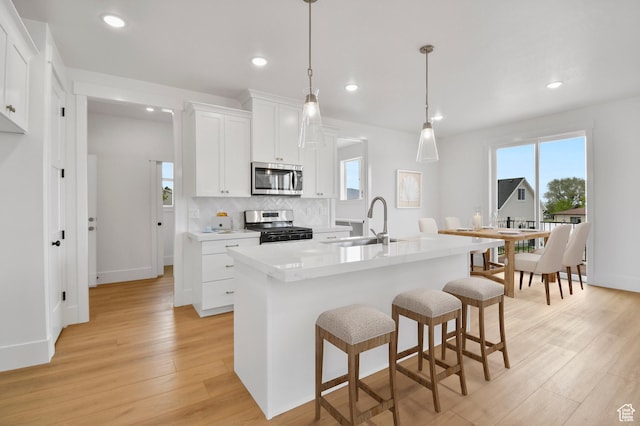 1323 E 370 S, Payson, UT 84651 - kitchen with stainless steel appliances, a sink, healthy amount of natural light, light wood-style flooring, and recessed lighting