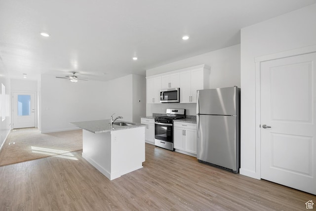 7164 Oquirrh Ranch Pkwy N, Eagle Mountain, UT 84005 - kitchen featuring appliances with stainless steel finishes, a sink, white cabinets, a ceiling fan, and a center island with sink