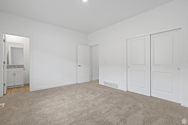 7164 Oquirrh Ranch Pkwy N, Eagle Mountain, UT 84005 - unfurnished bedroom with light colored carpet, a closet, baseboards, and ensuite bathroom