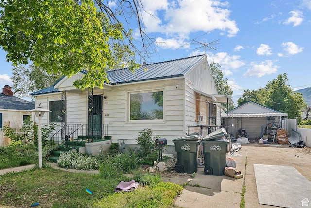 142 N Pinehurst Ave, Tooele, UT 84074 - view of front of property with a standing seam roof, metal roof, and a garage