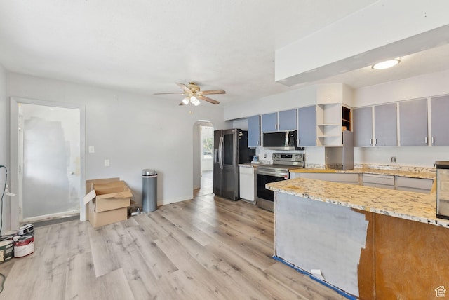 142 N Pinehurst Ave, Tooele, UT 84074 - kitchen with stainless steel appliances, arched walkways, light wood-style flooring, a ceiling fan, and open shelves