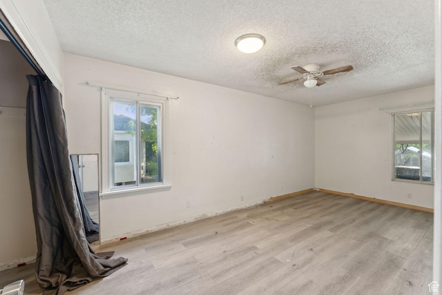 142 N Pinehurst Ave, Tooele, UT 84074 - spare room with light wood-type flooring, ceiling fan, a textured ceiling, and baseboards