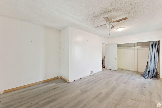 142 N Pinehurst Ave, Tooele, UT 84074 - unfurnished bedroom featuring light wood finished floors, a textured ceiling, a closet, a ceiling fan, and baseboards