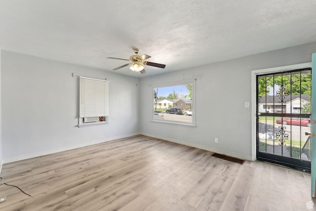 142 N Pinehurst Ave, Tooele, UT 84074 - spare room featuring light wood finished floors, a ceiling fan, baseboards, and a textured ceiling