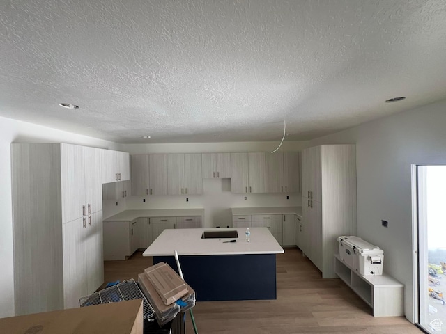 7230 S 525 E, Midvale, UT 84047 - kitchen with a kitchen island, a textured ceiling, and light wood finished floors