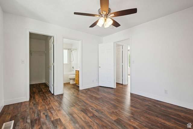 3018 S Leland Cv, South Salt Lake, UT 84106 - unfurnished bedroom with a walk in closet, wood finished floors, baseboards, and a closet