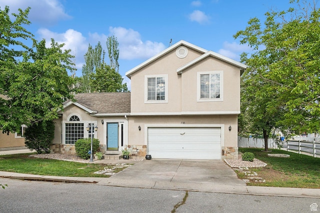 3018 S Leland Cv, South Salt Lake, UT 84106 - view of front facade with stone siding, stucco siding, an attached garage, driveway, and roof with shingles