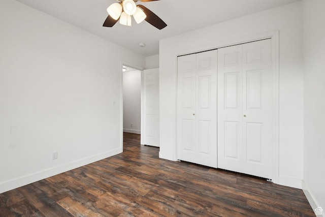 3018 S Leland Cv, South Salt Lake, UT 84106 - unfurnished bedroom featuring dark wood-style flooring, baseboards, a closet, and a ceiling fan