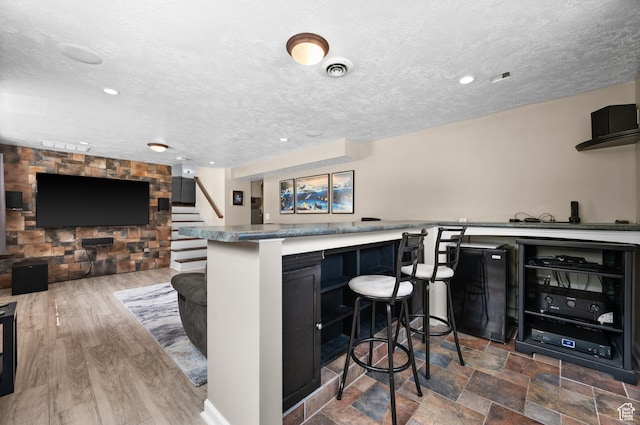 4314 S 615 E, Millcreek, UT 84107 - kitchen with a breakfast bar, a textured ceiling, recessed lighting, dark cabinets, and open floor plan